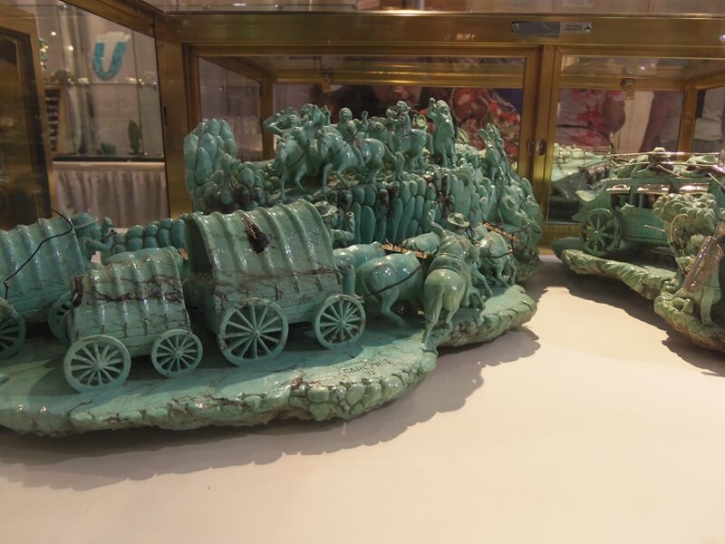 Carved turquoise depicting the beginning of the move West in the US.