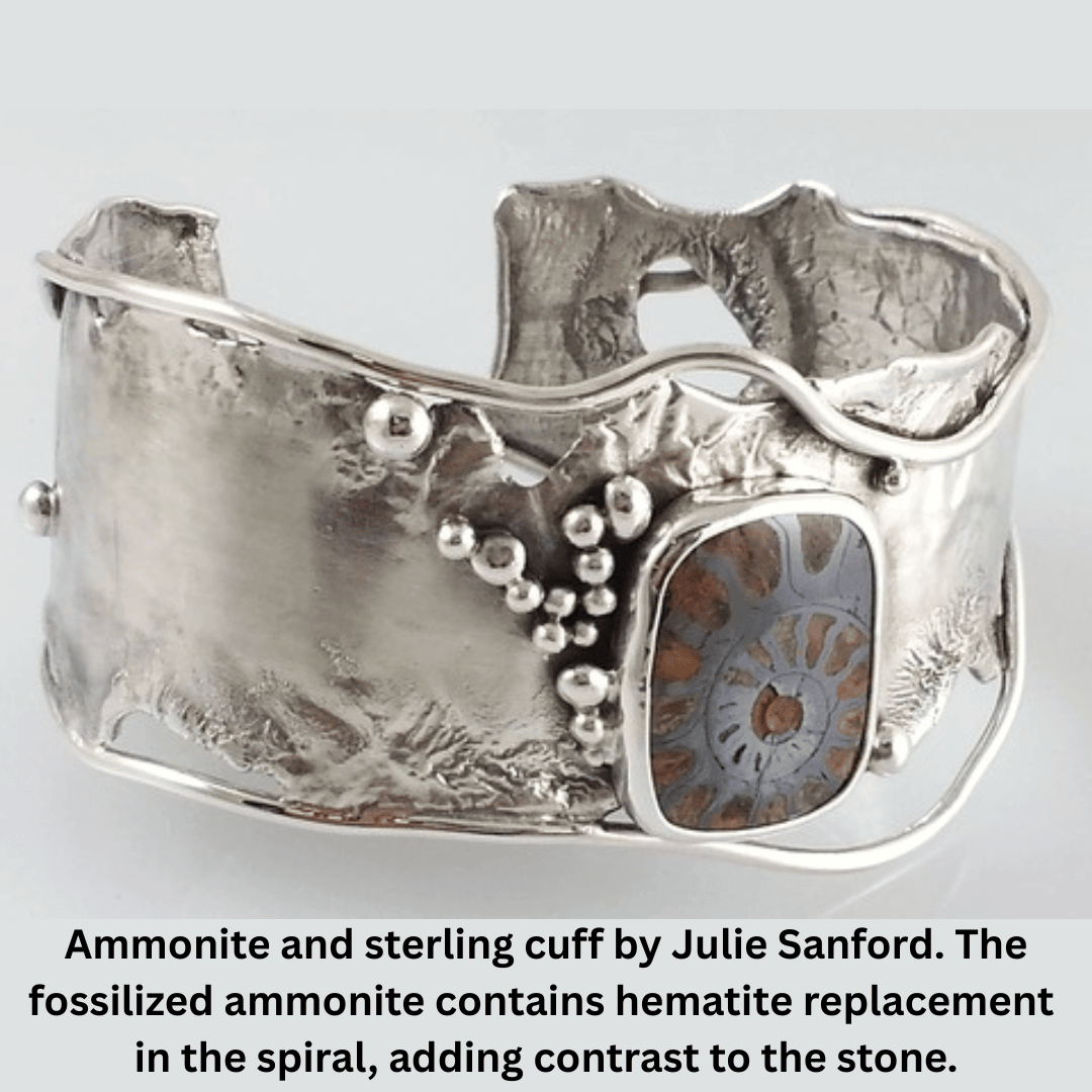 Ammonite and sterling cuff by Julie Sanford. The fossilized ammonite contains hematite replacement in the spiral, adding contrast to the stone.