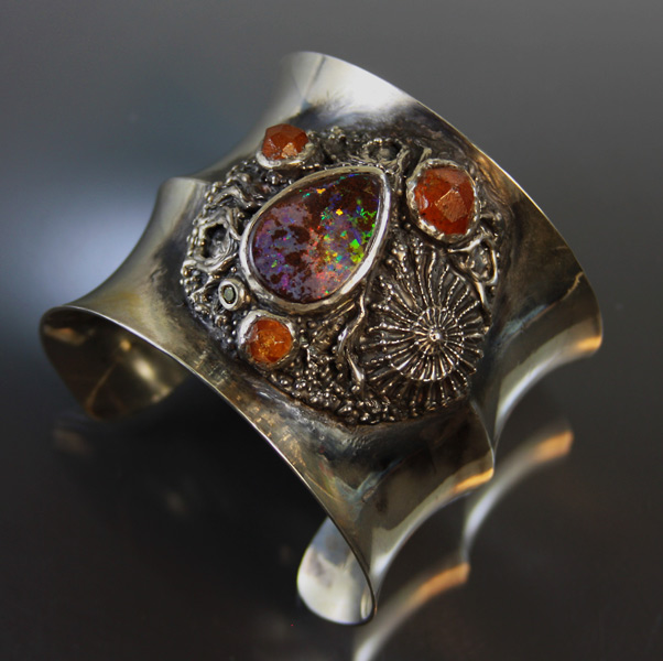 Yowah opal in wide sterling silver cuff bracelet with spessartite garnet crystals and green diamond