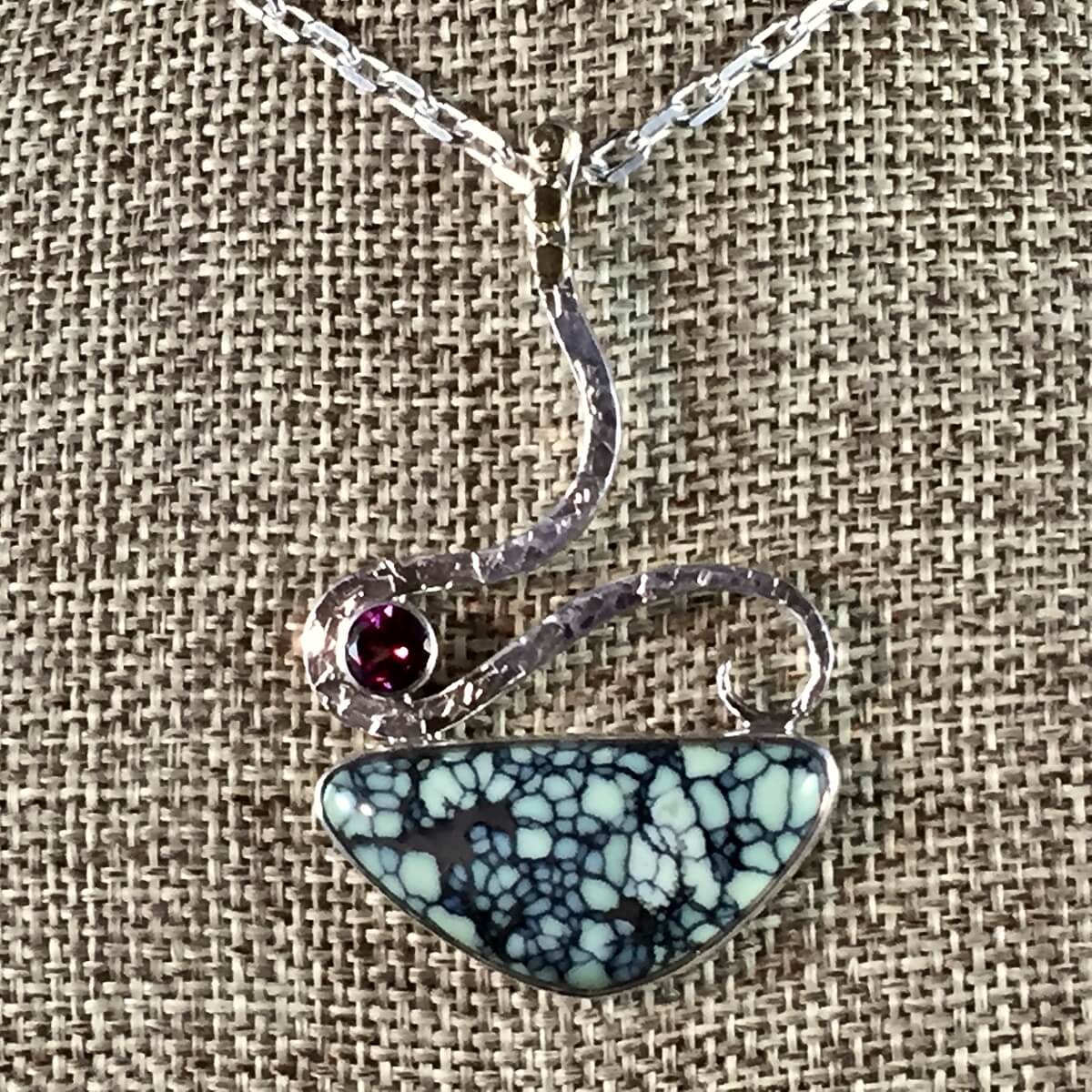 Beautiful New Lander Chalcosiderite and Rhodolite garnet pendant!
Set in sterling and fine silver, with 18K accents and hidden bail.
This is #2 of 190, from the Limited Edition "19" Collection. Also featured in the July issue of Rock & gem Magazine.
https://dancing-raven-stoneworks-llc.square.site/product/drs-19-202-19-collection-new-lander-pendant/85?cs=true