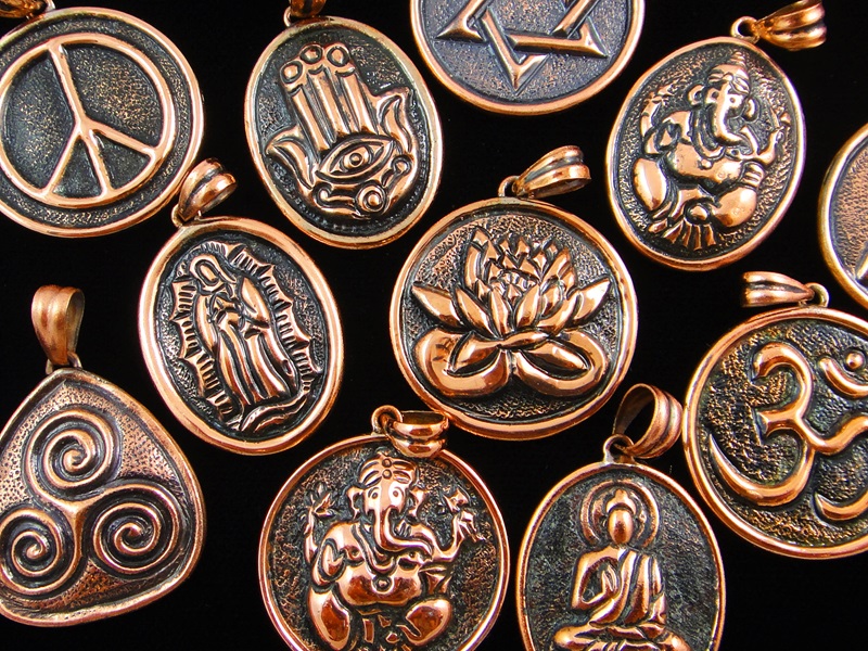 Handcrafted copper repousse pendants.