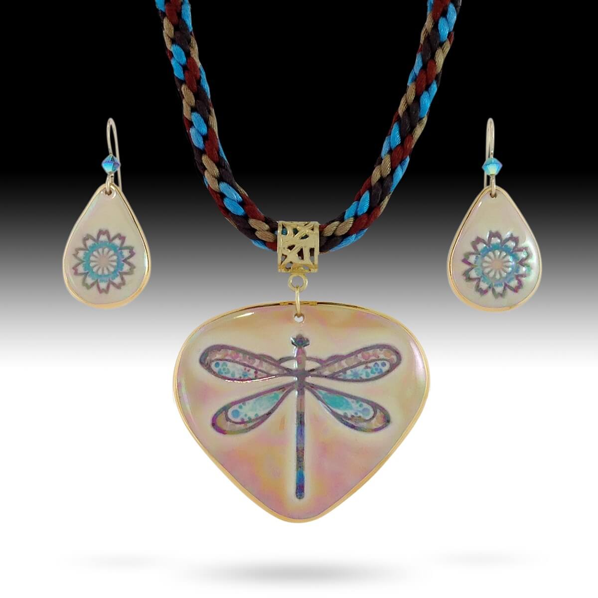Large dragonfly pendant displayed on a Kumihimo braided necklace with coordination flower earrings in our southwest color palette