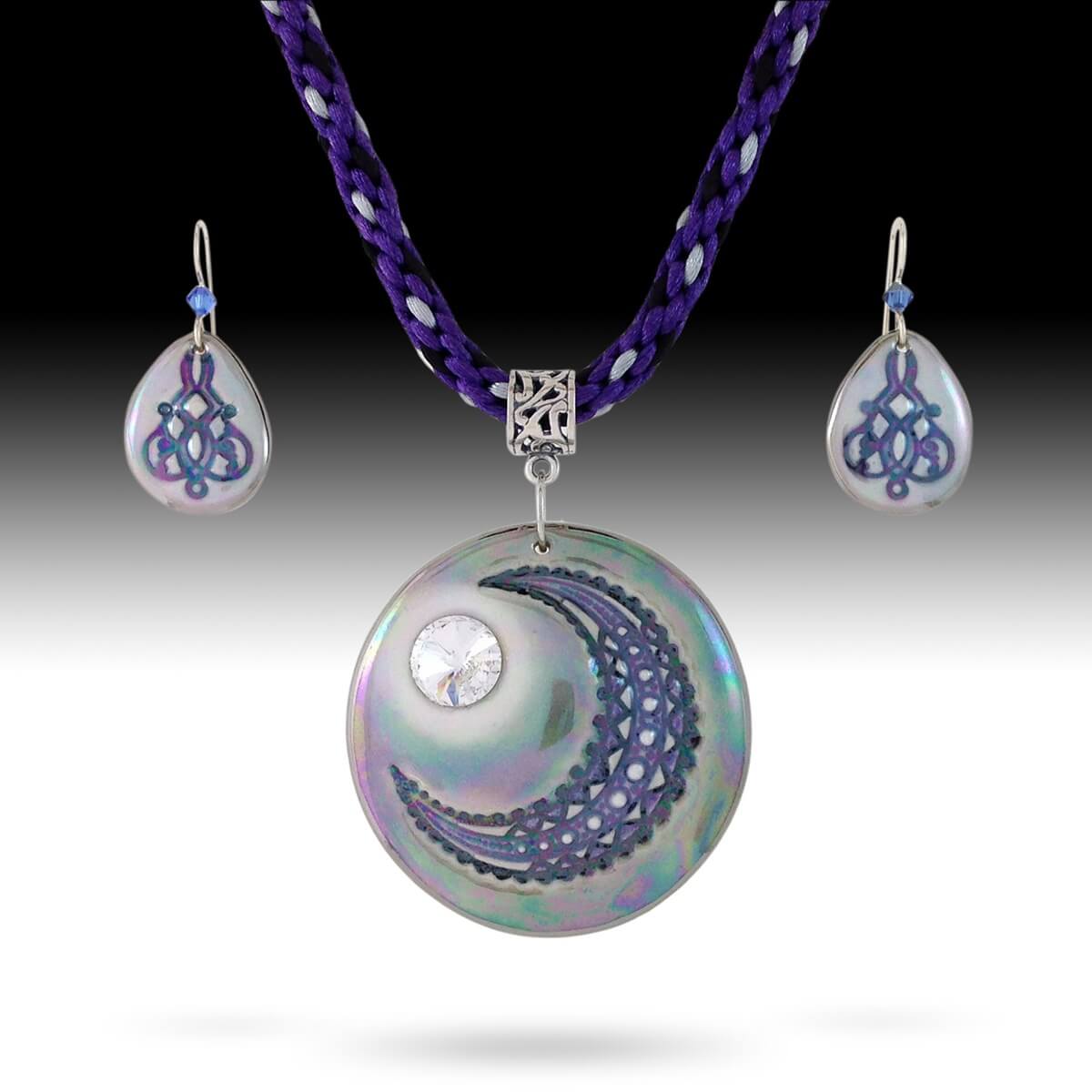 Filigree moon statement pendant displayed on an 8 strand Kumihimo braided necklace with coordinating earrings.