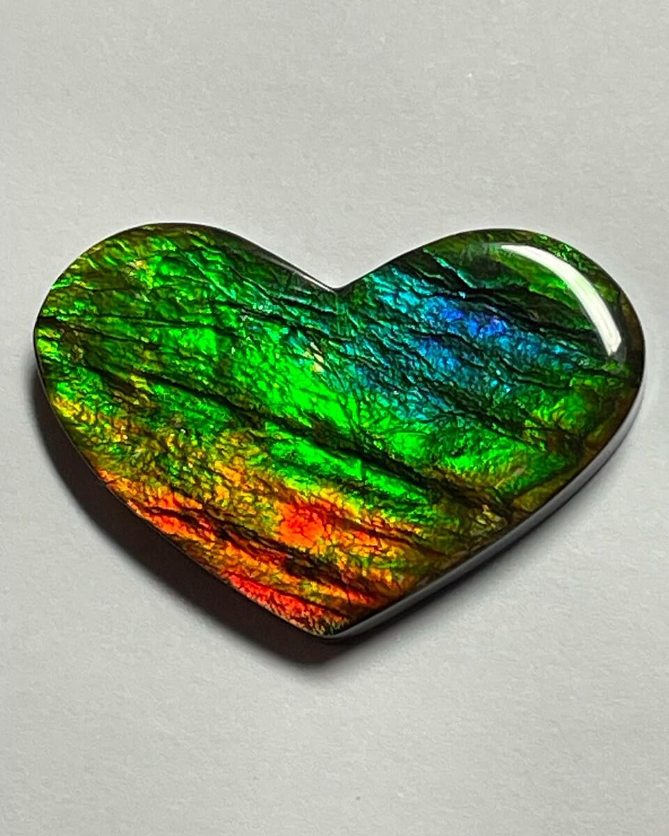 An Ammolite heart cabochon